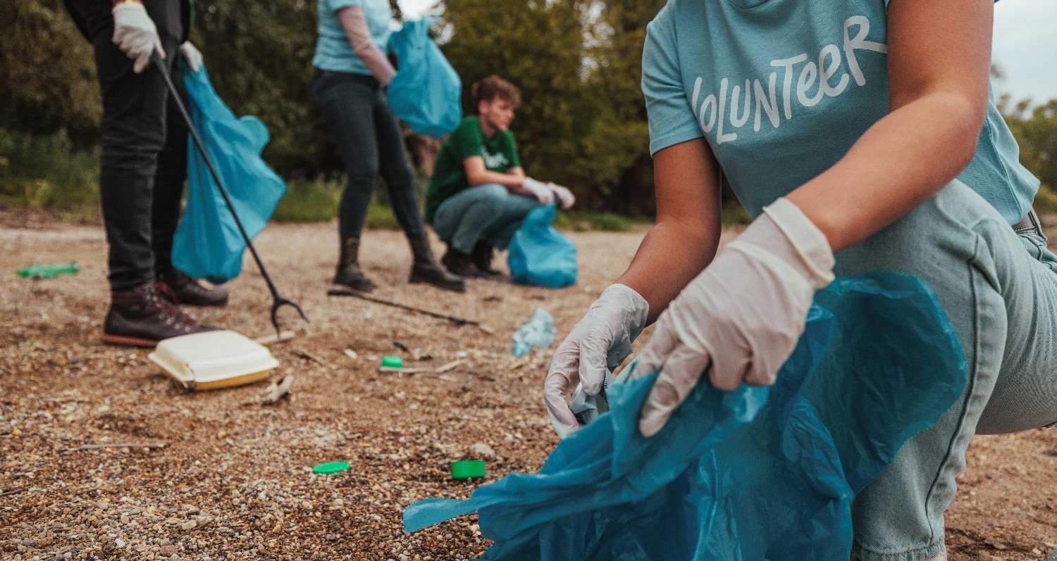 Team of volunteers cleaning up their community by picking up trash