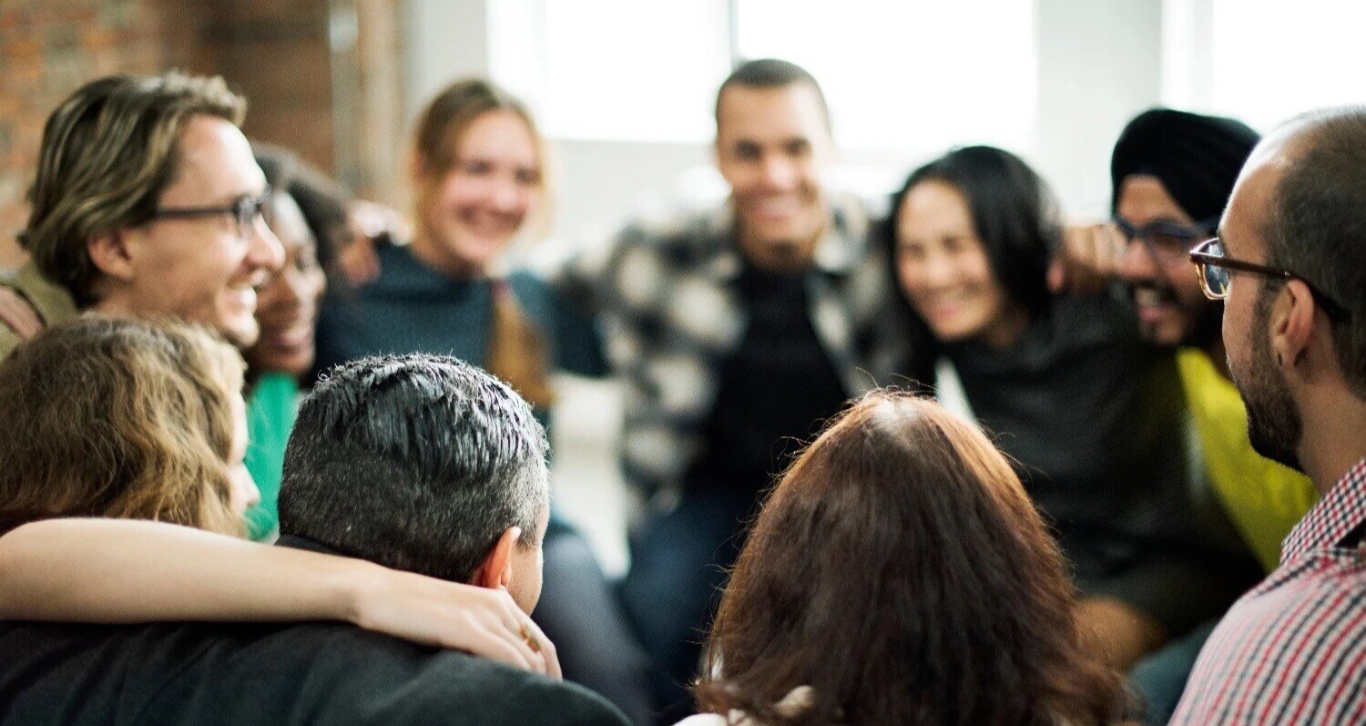 Small, close-knit team huddling together for encouragement